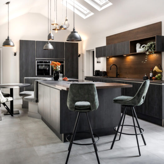 A dark industrial style kitchen with natural tones and textures